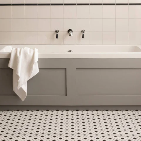 Jet Black Omega Dado (above) Chancel Grey Field Tile (below) Black and White Honeycomb Mosaic (floor)